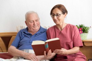Female caregiver helping senior man