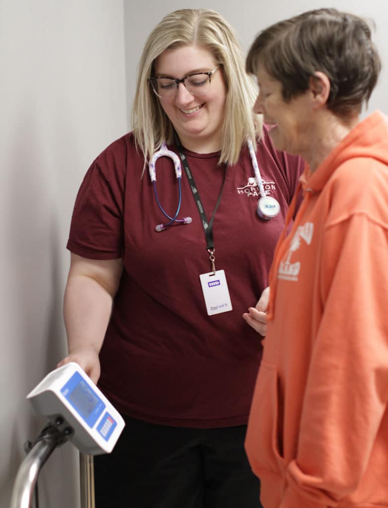 Smiling Horizon nursing staff treating client.